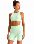 Woman wearing a light green athletic outfit on a white background